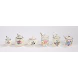 Six Poole pottery preserve and condiment jars and covers, with foliate decoration (6)