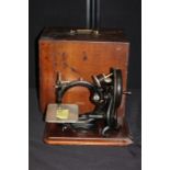 Willcox & Gibbs "Automatic" silent sewing machine, the ebonised body with remains if gilt