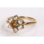 9 carat gold ring, set with pearls and a purple stone to the flower head