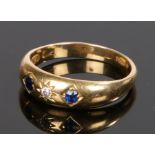 18 carat gold diamond and sapphire set ring, with a central diamond flanked by a sapphire to