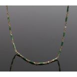 Gold and enamel chain, the green enamel links with three pearl divides and clip end, 46cm long