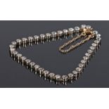 Diamond set bracelet, with a row of forty-one round cut diamonds and clasp end, 16cm long