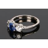 18 carat white gold sapphire and diamond set ring, the central sapphire at 1.19 carat flanked by a