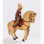 German D.R.G.M. tinplate clockwork toy, of a Native American rider and horse, 9cm long