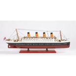 Model depicting RMS Titanic, on a red plinth base with name plate, 54cm long, 19cm high