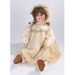 Scoenau & Hoffmeister bisque headed doll, with articulated limbs and brown hair, the back of the