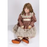 A. Lanternier & Cie Limoges doll, with brown curly hair, blue eyes and wearing a grey silk dress,