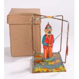 British made tinplate clockwork toy, of a fishing clown under a frame, in the original box