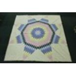 Modern needlework quilt with star design to the centre, 260cm x 260cm