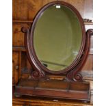 Victorian mahogany dressing table mirror, the oval plate on scroll supports, the swept base with