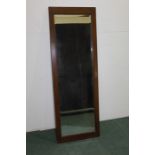 Bevelled wall mirror, housed in a mahogany frame, 52.5cm x 152cm