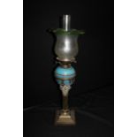 19th Century oil lamp, with a green and frosted glass shade above a blue pottery reservoir and a