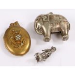 Silver plated novelty rattle, as an elephant, together with a pendant and locket, (3)