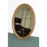 Oval bevelled wall mirror, housed in an acanthus leaf and scroll decorated gilt frame, 98cm x 68cm