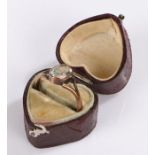 Yellow metal ring, with a pale blue stone, housed within a heart shaped jewellery box, (2)