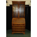 George III style yew wood bureau bookcase, the astragal glazed top above a sloping fall enclosing