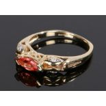 9 carat gold padparadscha sapphire, the marquise cut padparadscha at 0.52 carat flanked by