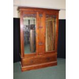 Art Nouveau wardrobe, the dentil pediment above two bevelled mirror doors, with central stylised