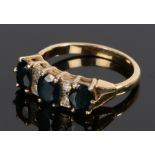 18 carat gold sapphire set ring, with three oval sapphires and four round cut stones to the head,