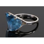 18 carat white gold and Swiss blue topaz set ring, the blue topaz set to an angle with four claw