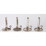 Set of four 19th century Sheffield plate chamber stick, the acanthus leaf cast stems on dished bases