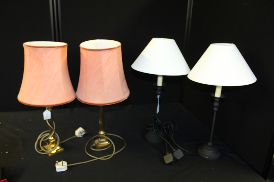 A pair of brass table lamps of Corinthian column design, together with another pair of table lamps
