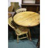 Pine dining table, with circular top, raised on a turned stem and tripod legs, 90cm diameter, two