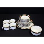 Atlas china part tea service, the black borders decorated with cartouches of floral sprays,