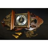 Walnut veneered wall clock, with figural pediment above the silvered dial with Roman numerals, two