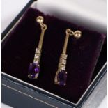 Pair of drop earrings, set with purple stones to the base