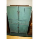 Turquoise painted pine cabinet, with two panelled cupboard doors above three central drawers and a