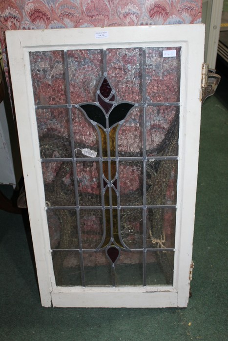 Stained glass window, with central red, yellow and green stylised foliate decoration, 52.5cm x 94.