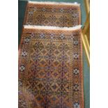 Pair of Turkoman Middle Eastern carpets, the brick red grounds with blue and cream foliate