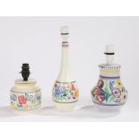 Three Poole pottery reading lamps, with polychrome foliate and scroll decoration (3)
