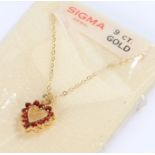 9 carat gold garnet set necklace, in the form of a heart