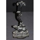 Cast iron door stop with a dog resting below a branch, 38cm high
