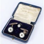 Pair of cufflinks, with a faux mother of pearl and green surround