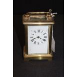 Gilt brass French carriage clock, with a white enamel dial with Roman hours