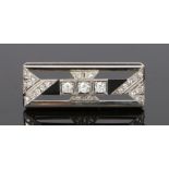 Art Deco diamond and onyx brooch, with round cut diamonds at an estimated total diamond weight of