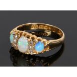 18 carat gold opal and diamond set ring, with three opals divided by three diamonds to either side