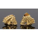 Pair of 18 carat gold cufflinks, with horses heads to the face with a hinged toggle, 22.5 grams,