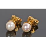 Pair of 14 carat gold pearl set earrings, with a single pearl to the end