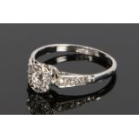 Platinum and diamond set ring, the head set with a round cut diamond to the star mount above