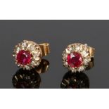 Pair of 9 carat gold ruby set earrings, with central rubies and stone surround forming a flower