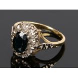 18 carat gold sapphire and diamond set ring, the oval sapphire with a diamond surround, ring size