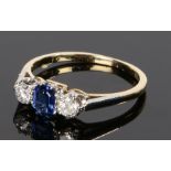 18 carat gold sapphire and diamond ring the central sapphire flanked by a diamond to either side,