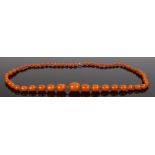 Butterscotch amber necklace, with graduated beads, the largest bead 25mm long, 54.3 grams, 85cm