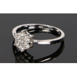 18 carat white gold diamond set ring, the diamond set flower head at a total of 0.37 carats over