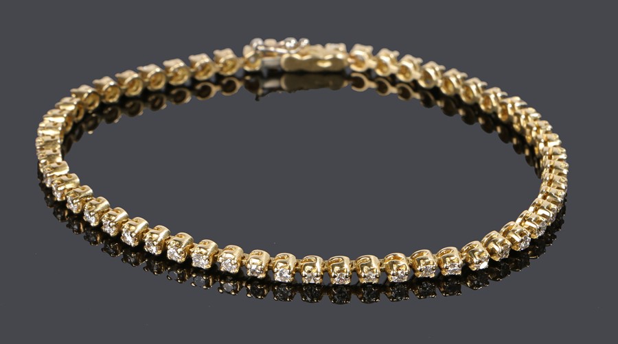 18 carat gold diamond set bracelet, with a row of fifty-four round cut diamonds wot clasp ends, 19.