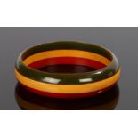 Bakelite bangle, with red, orange and black bands, 8cm wide